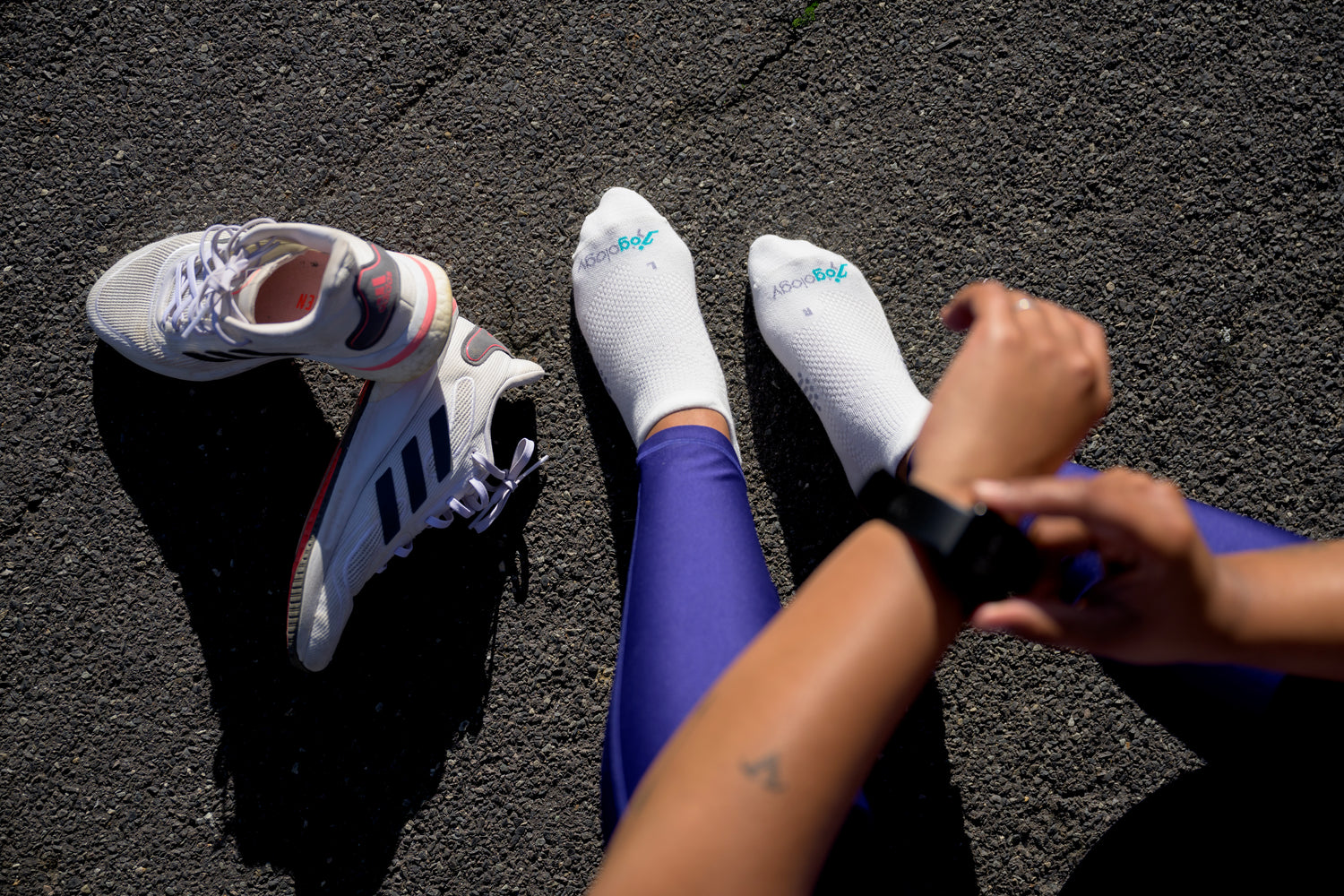 women setting fitness tracker wearing jogology socks