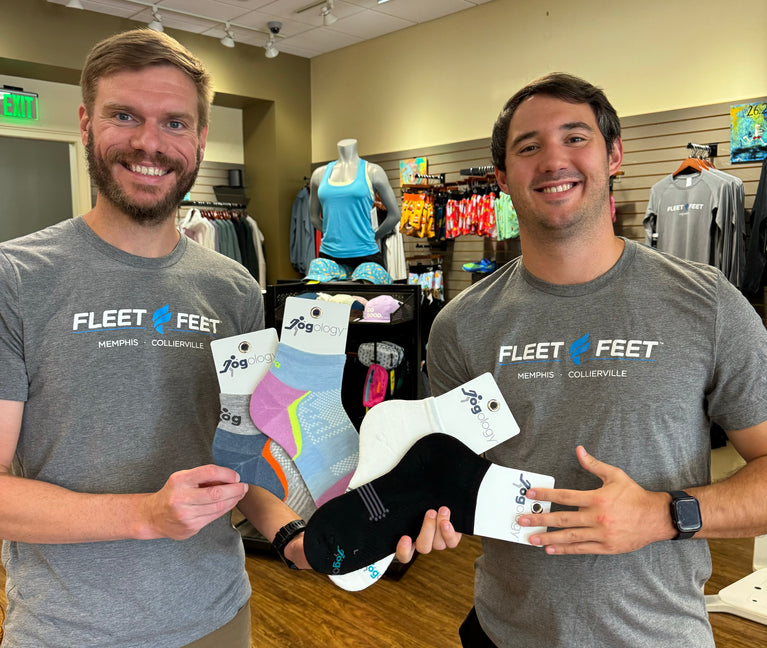 fleet feet sale staff presenting a splay of jogology socks